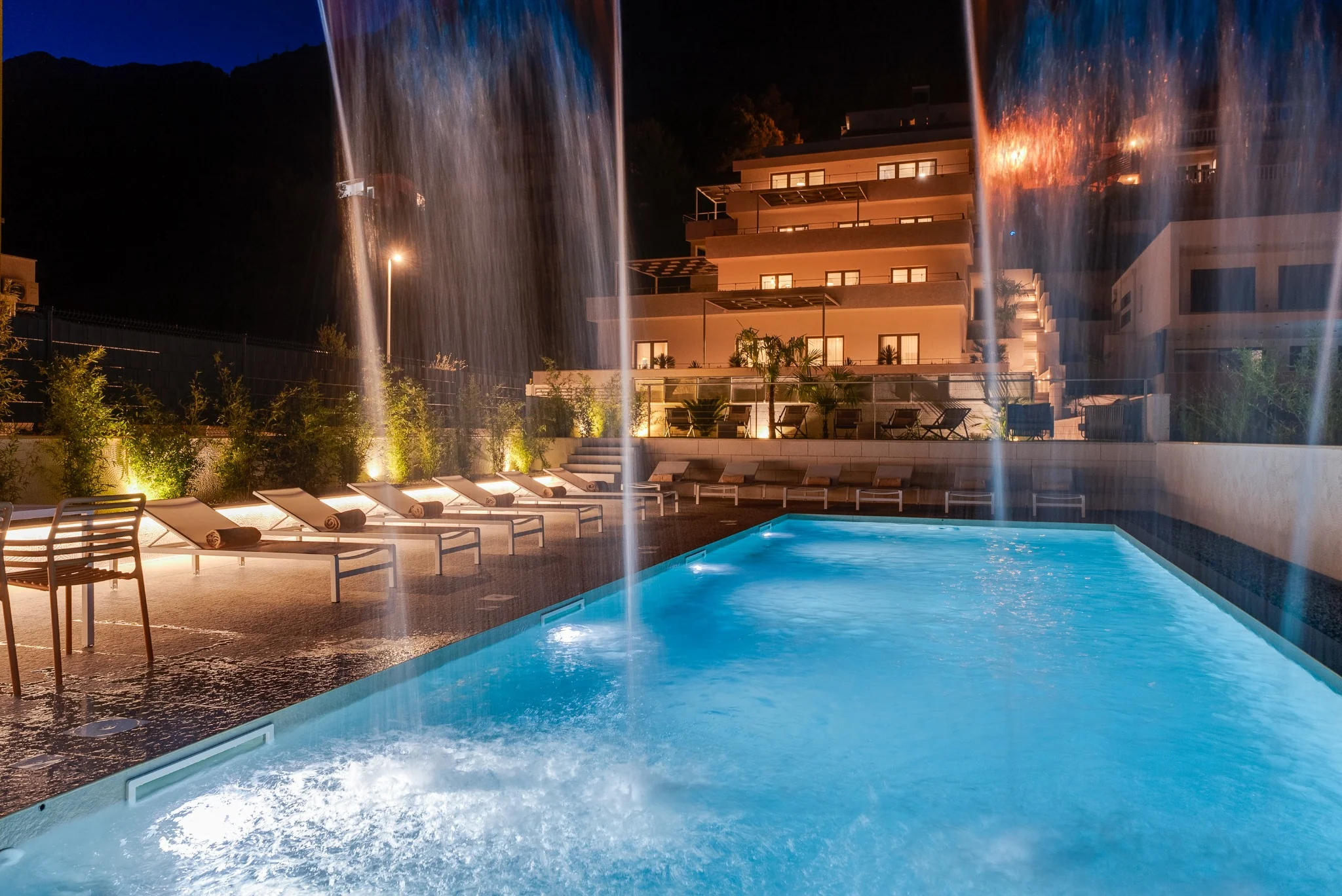 Private pool at ALMISSUM Residences at night